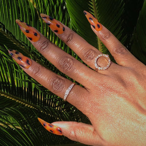 Manicure hand wearing tortoiseshell press on nails.